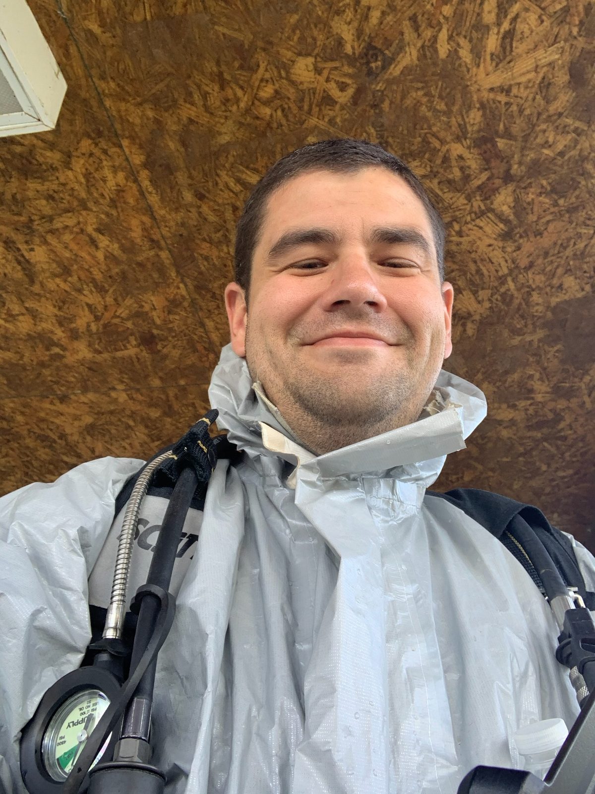 HazMat ACE instructor in a chemical protective suit with a taped collar and SCBA, ready to make entry.